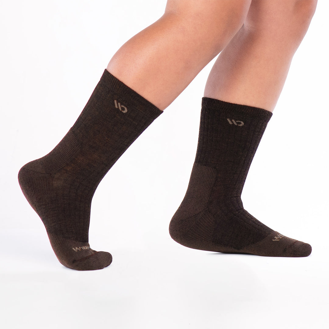 Model walking to the right lifting back leg wearing the 9001 in walnut