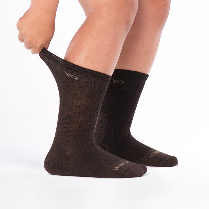 Model pulling on cuff from the back wearing the 9001 in walnut