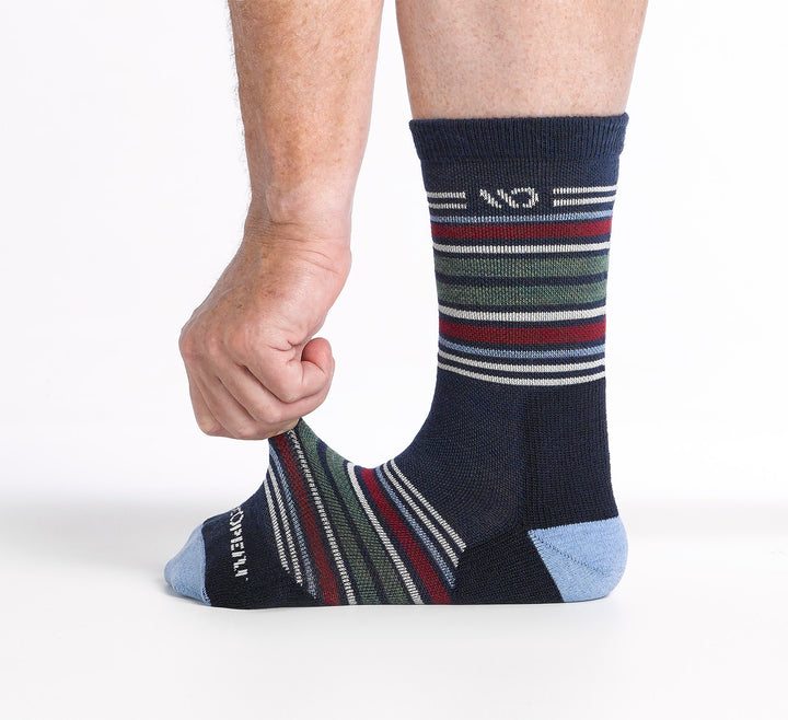 On model image of one foot with model stretching the top of the foot of the 9005 multi stripe micro crew in eclipse