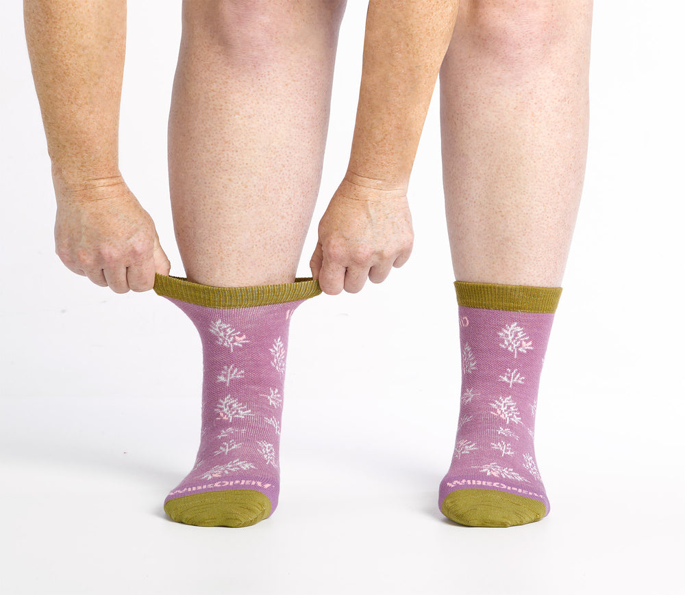 on model image of model stretching the top cuff of the 9503 foliage micro crew sock in violet