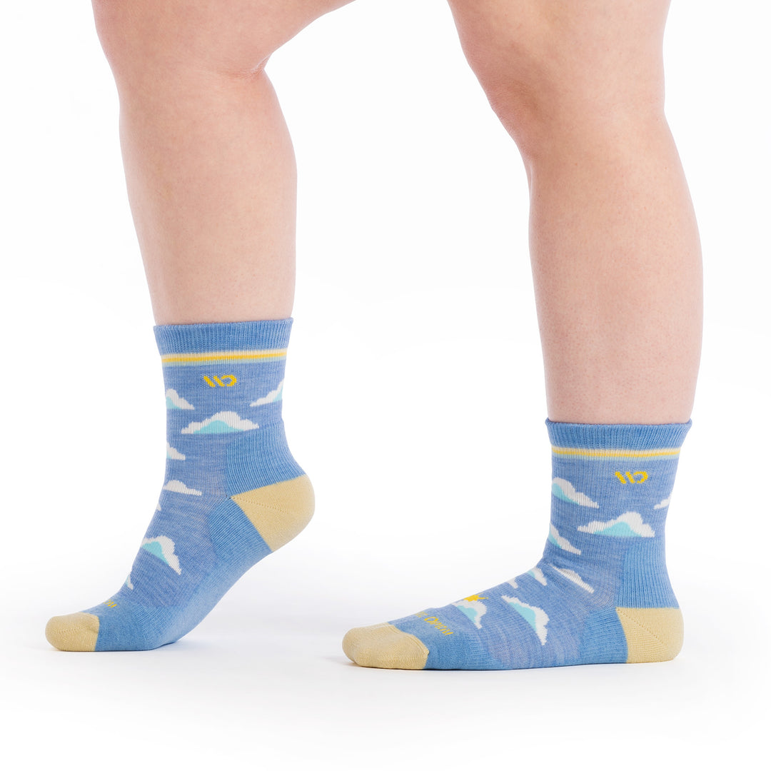 on model image with both feet to the side and front foot raised wearing the cloud hopper in sky