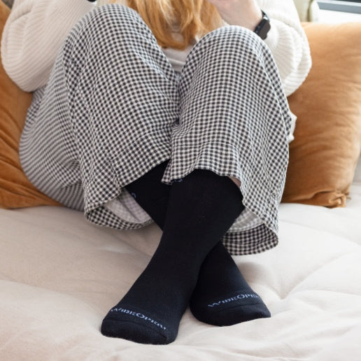 Shop lightweight socks - feet wearing solid gray socks knit from lightweight Merino