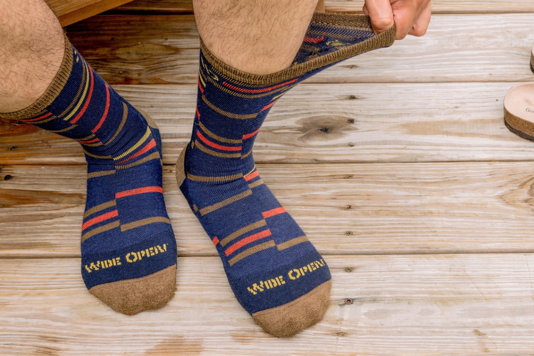 Overhead view of man's socked feet showing stretch of socks standing on deck