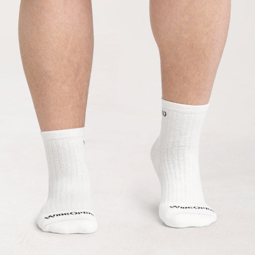 A pair of wide feet in wide white socks