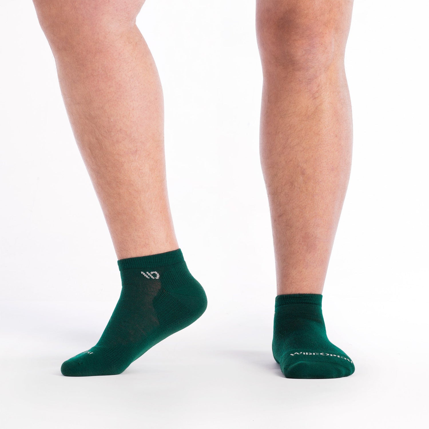 Feet wearing wide green socks in a quarter height