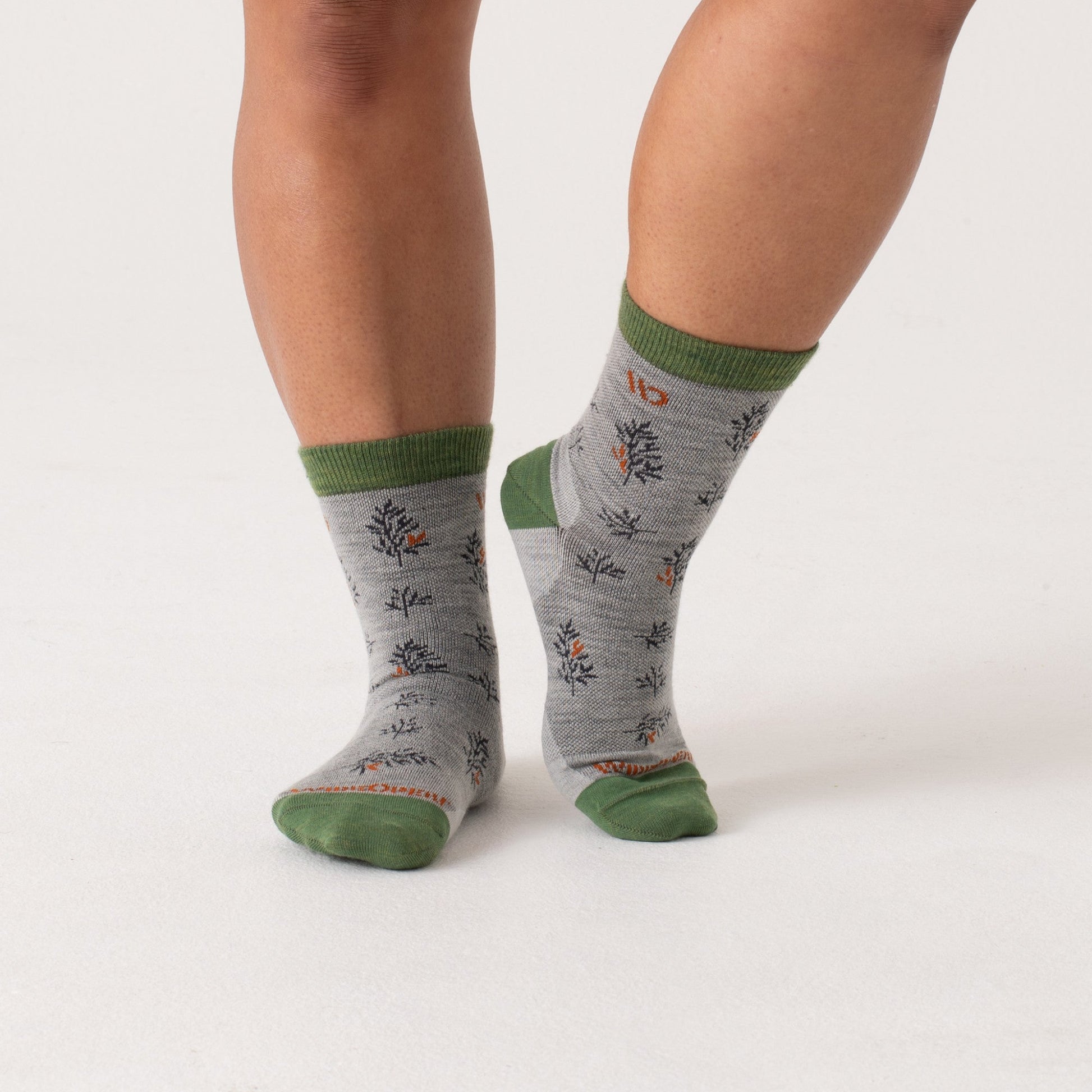 Micro Crew on model with green heel/toe/cuff, gray body and navy design --Light Gray/Teal/Denim/Taupe
