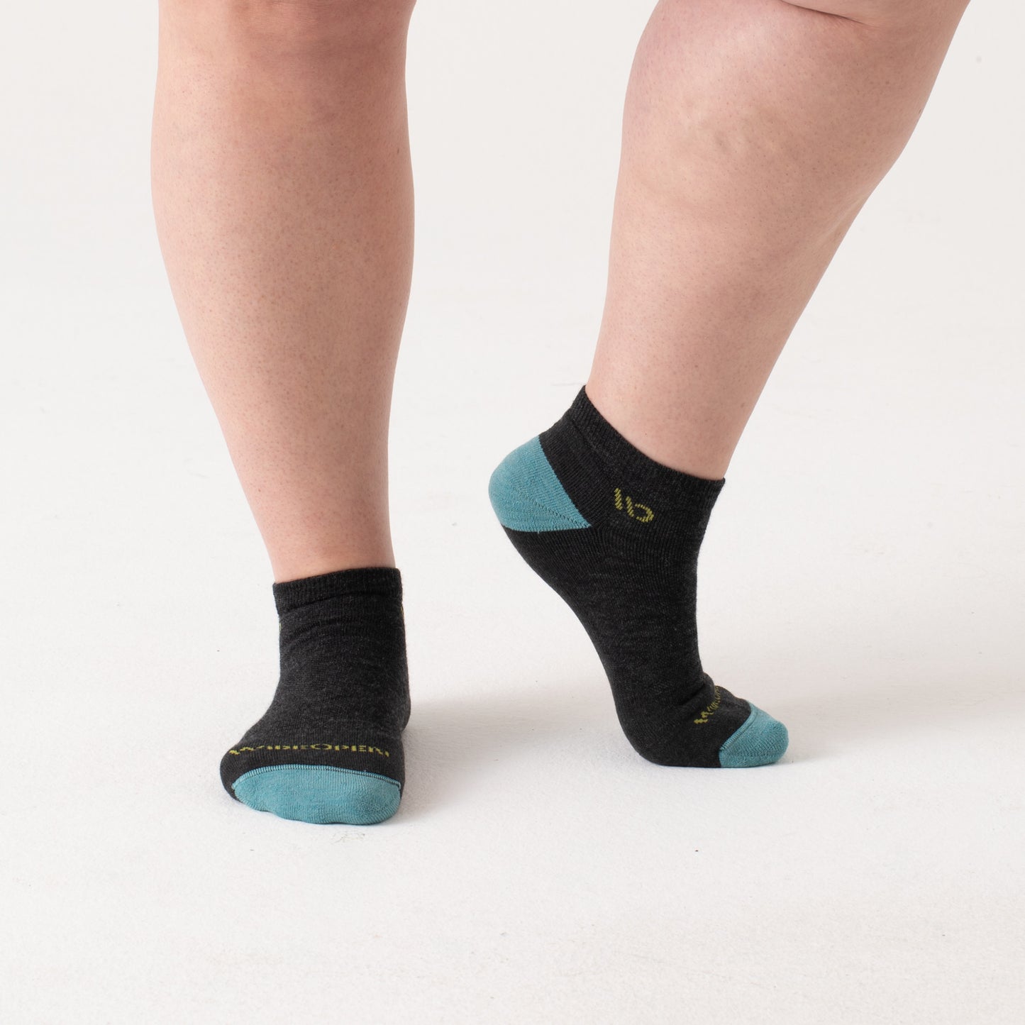 On model: No shows with aqua heel/toe and yellow logo, with charcoal body --Charcoal