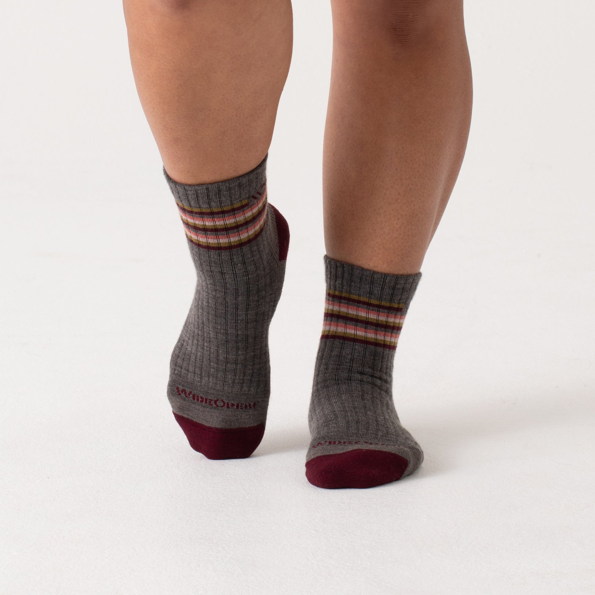On model Micro Crews: maroon heel/toe, taupe body with Stripes below the cuff --Taupe