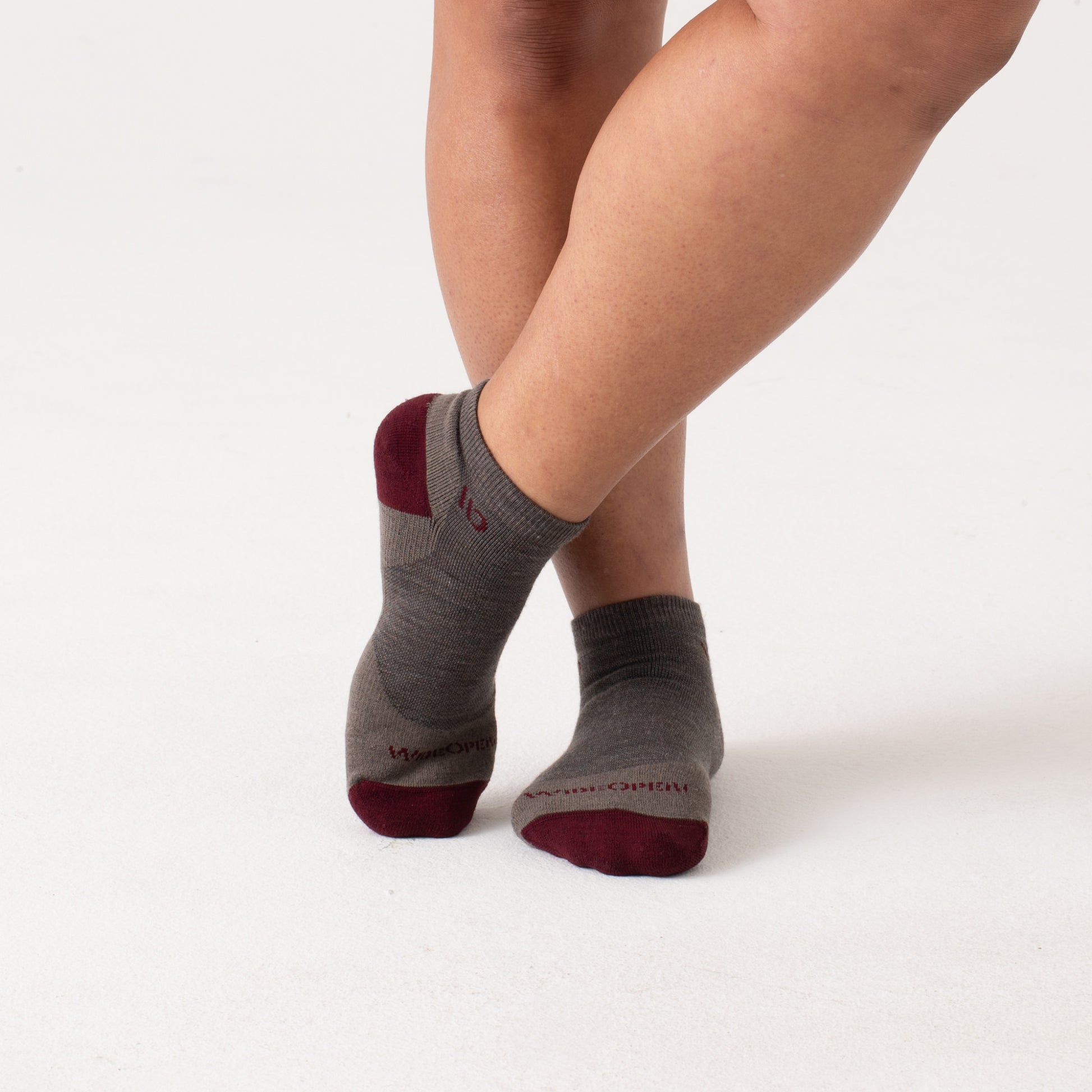 On model: No Shows with maroon heel/toe and logo, with taupe body --Taupe