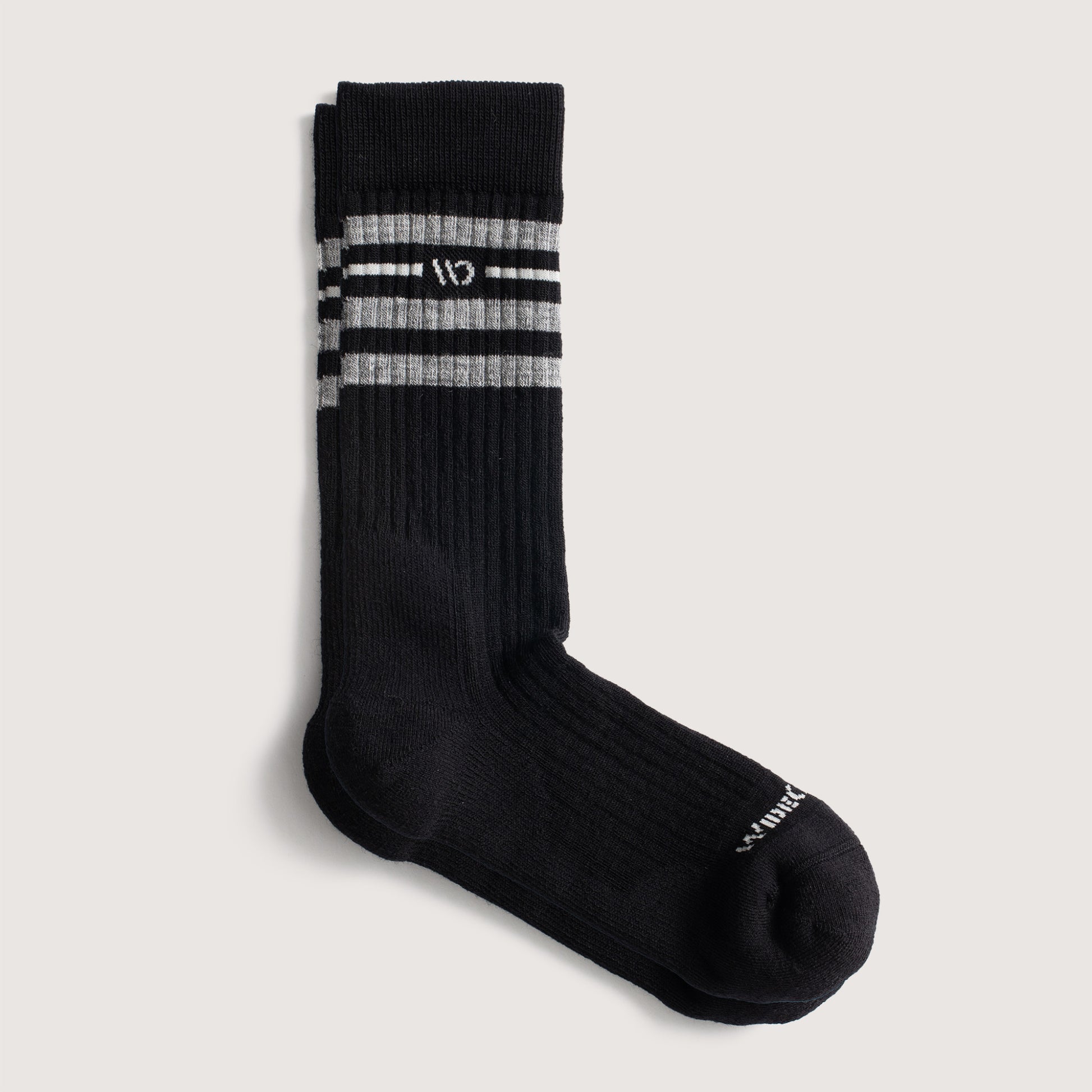 Flat socks, featuring white logo, with black body, and gray stripes below the cuff --Black