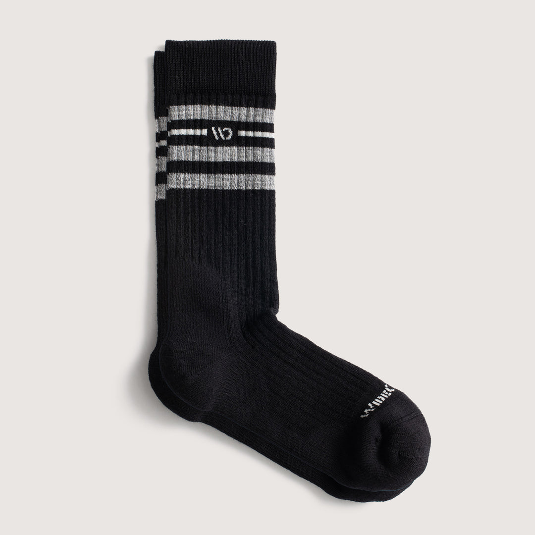 9002 Black, flat image, featuring white logo, with black body, and gray stripes below the cuff