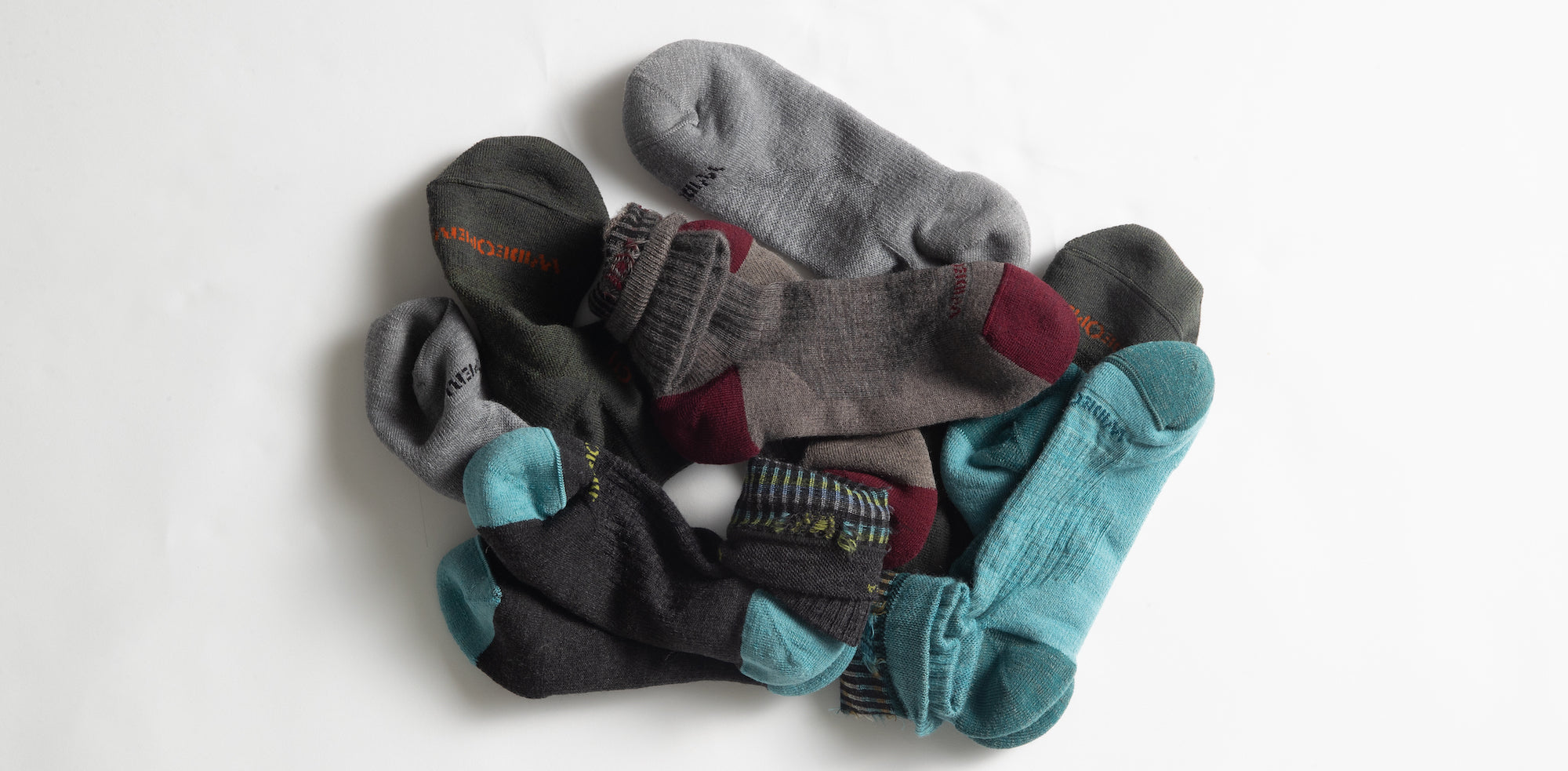 A pile of Wide Open socks roughly bundled together in pairs.