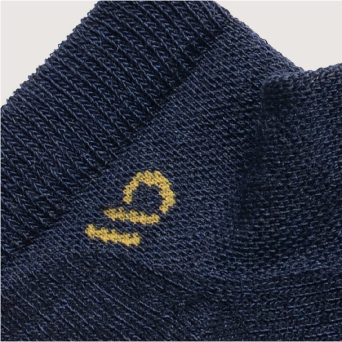 Detail featuring a yellow logo and denim body --Black/Denim/Forest