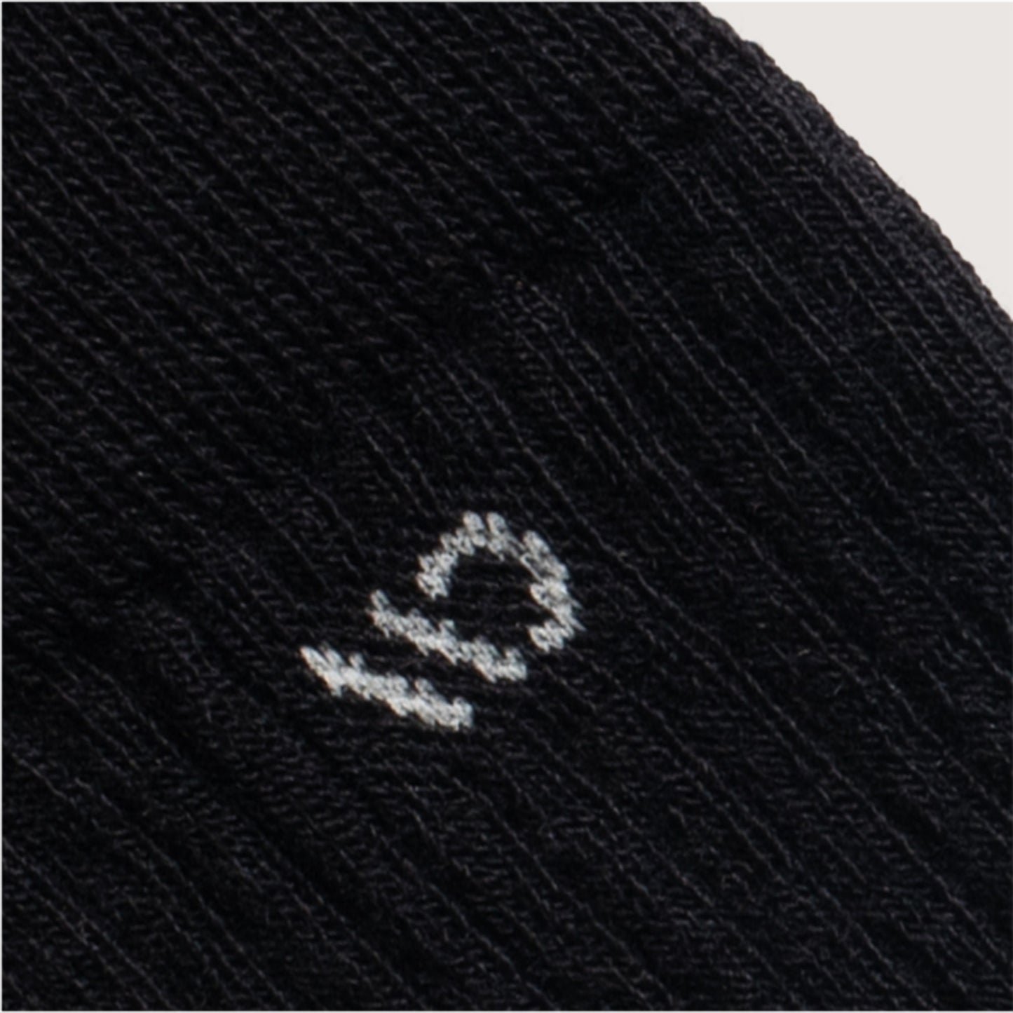 detail image of 9001 Black, featuring a white logo and black body --Black