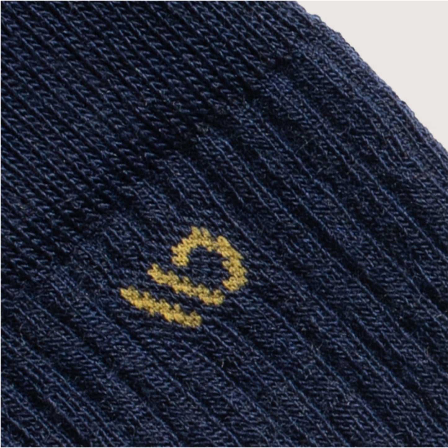 Detail featuring a yellow logo and navy body --Denim