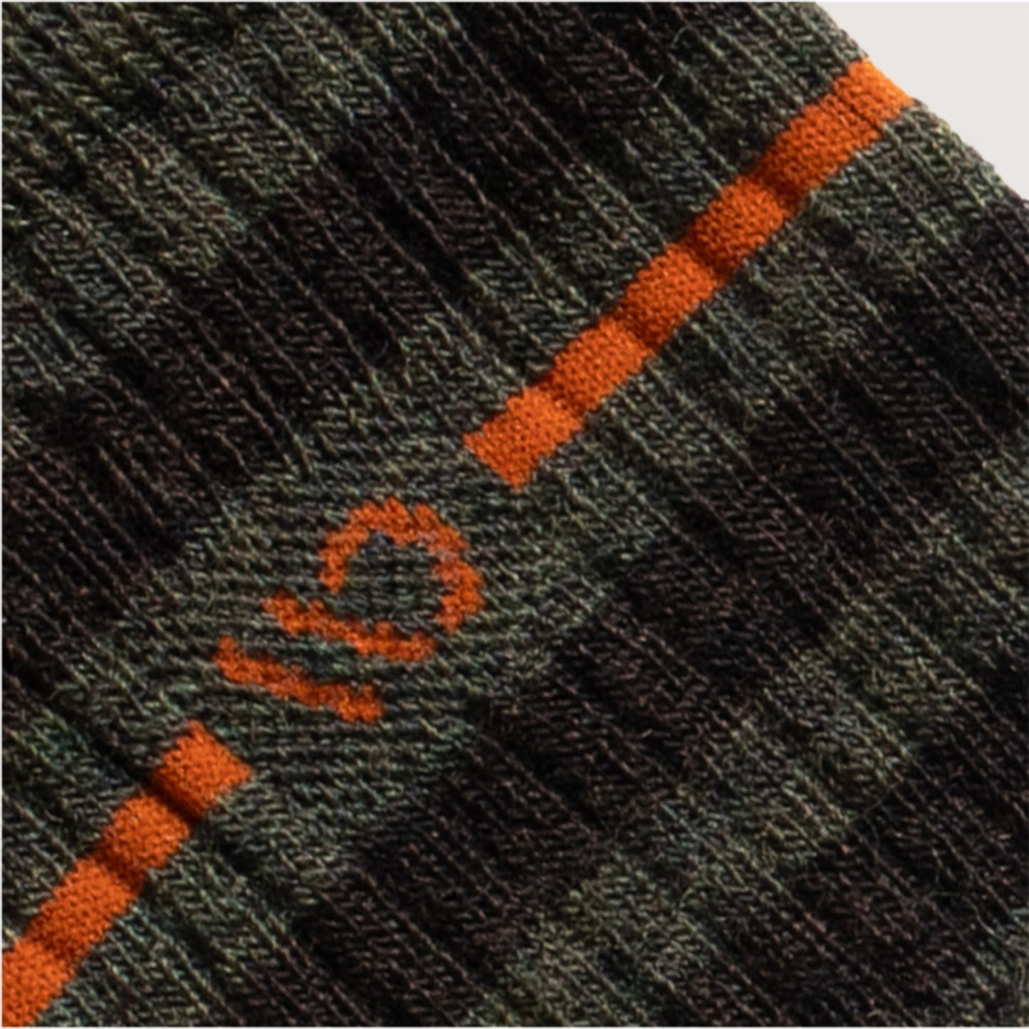 Detail featuring an orange logo and stripe, wider dark green and forest stripes --Forest