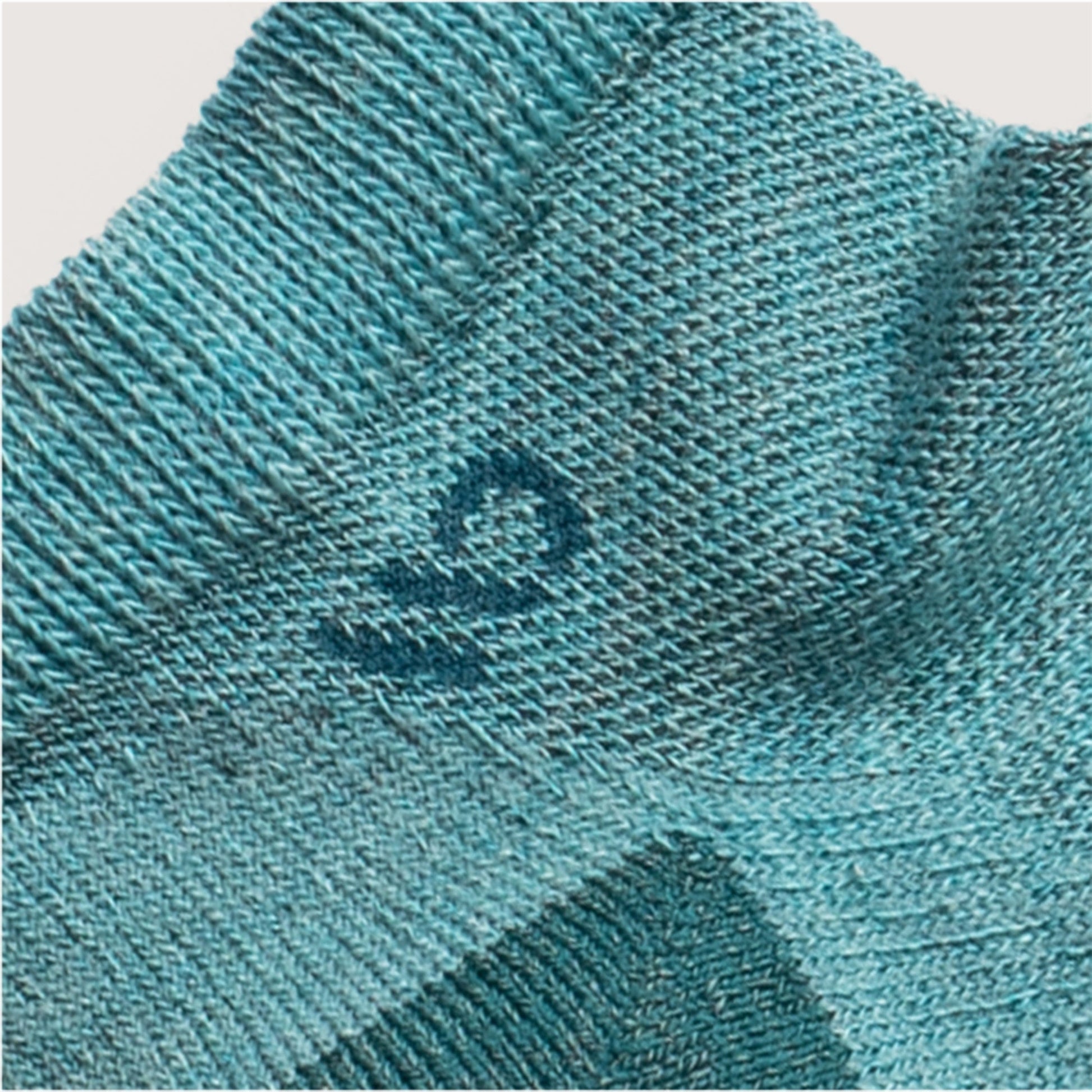Detail featuring a teal logo and heal, with light teal body --Light Teal/Denim/Taupe