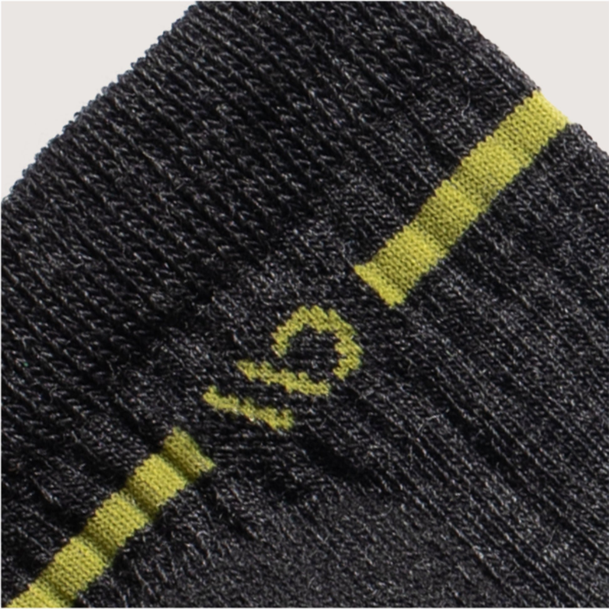 Detail featuring a yellow logo and stripe around the cuff--Charcoal