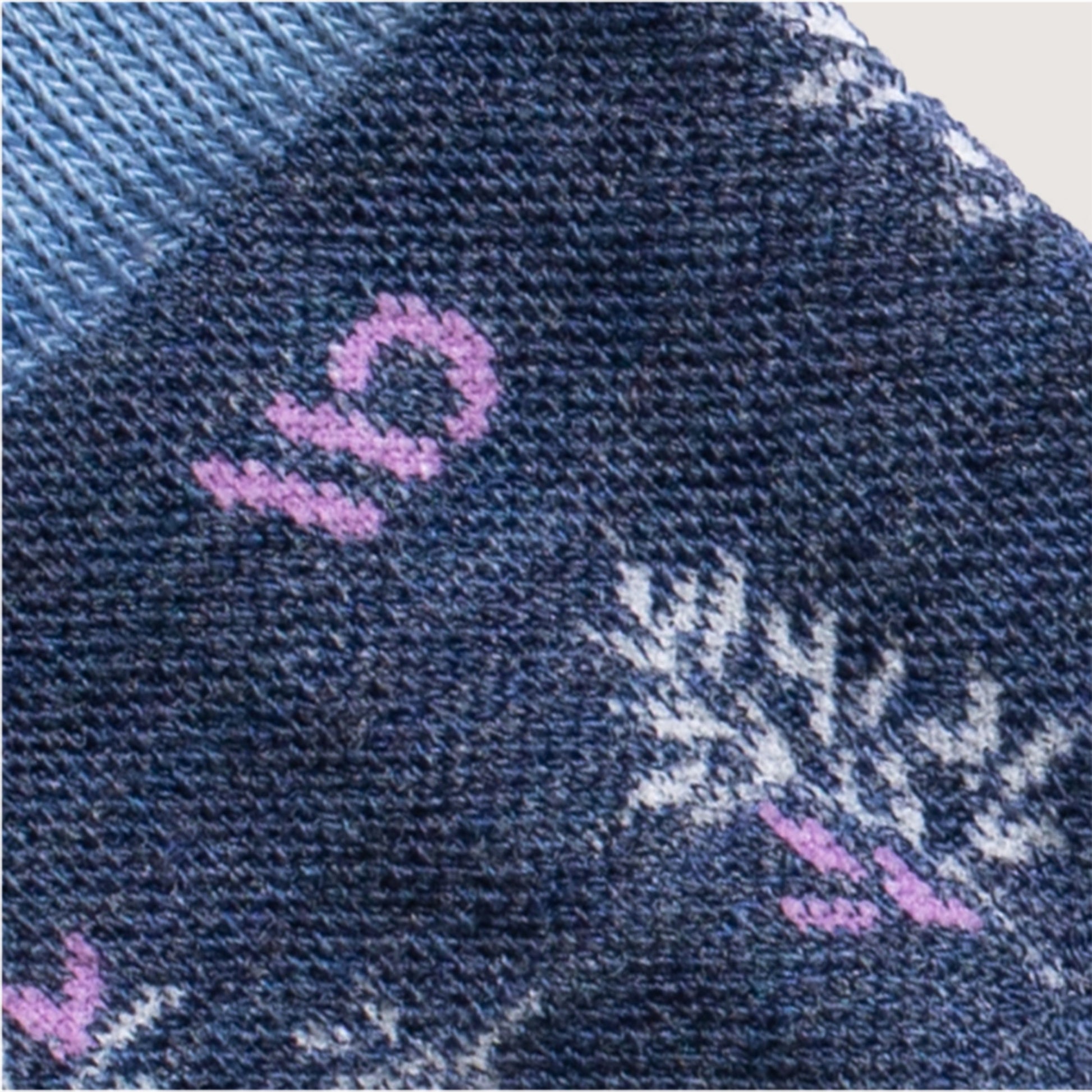 Detail featuring a lavender logo and design in white --Denim