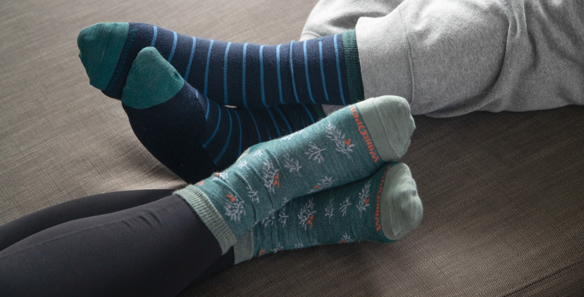 Two pairs of feet looking cozy in Wide Open Socks