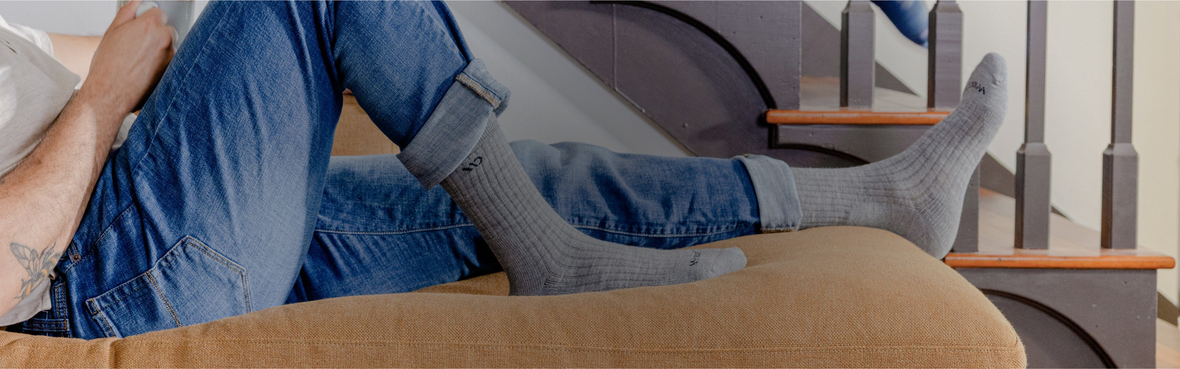 A man looking very relaxed in his gray Wide Open socks