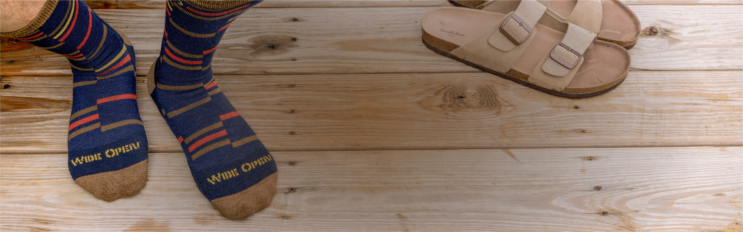 Feet wearing wide-fitting socks with an intermittent stripe pattern