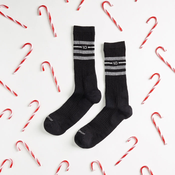 Solid black socks surrounded by candy canes