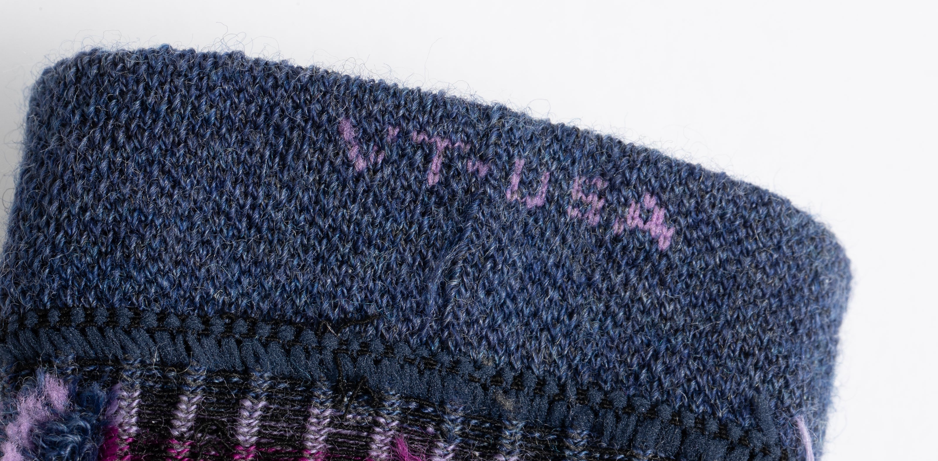 The inside of a sock with VT-USA knit into the cuff.
