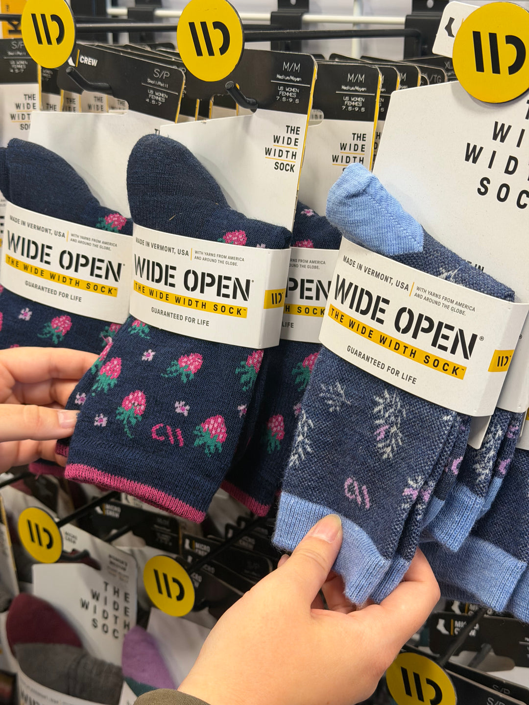 Photo of wide open socks on a rack in store 
