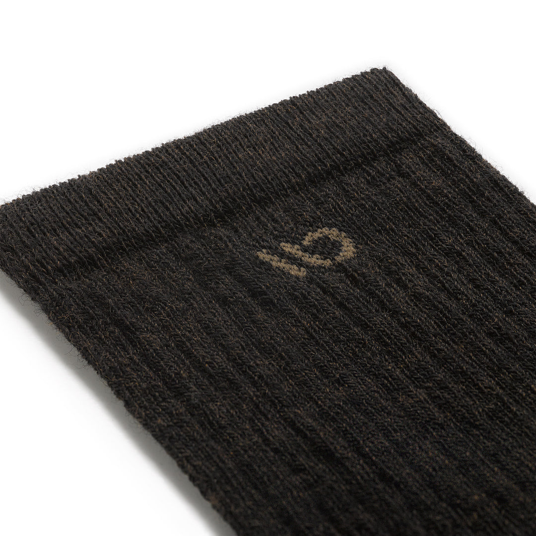 Close up detail image of the 9001 cuff in walnut colorway and light brown logo