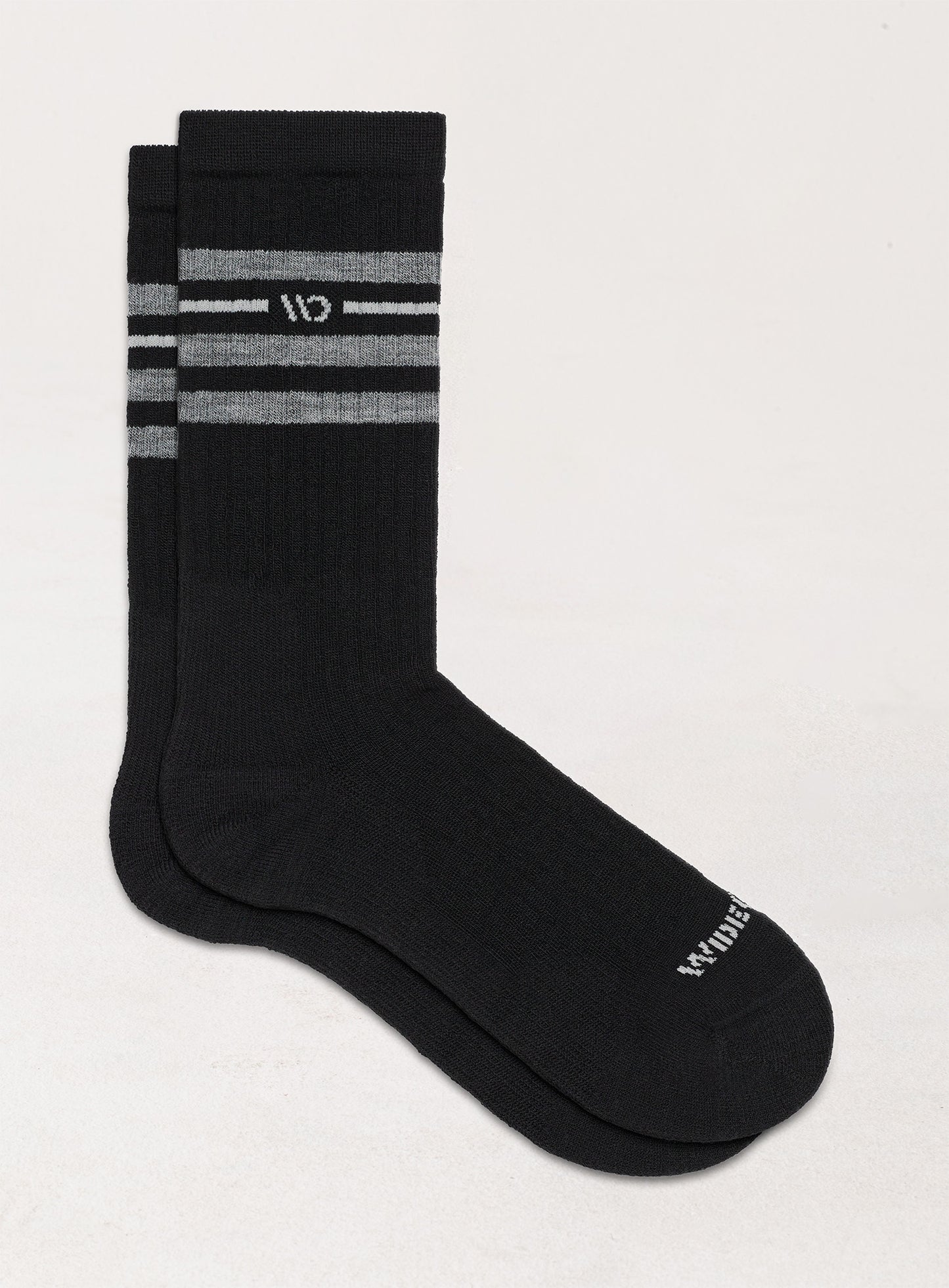 Flat socks, featuring white logo, with black body, and gray stripes below the cuff --Black