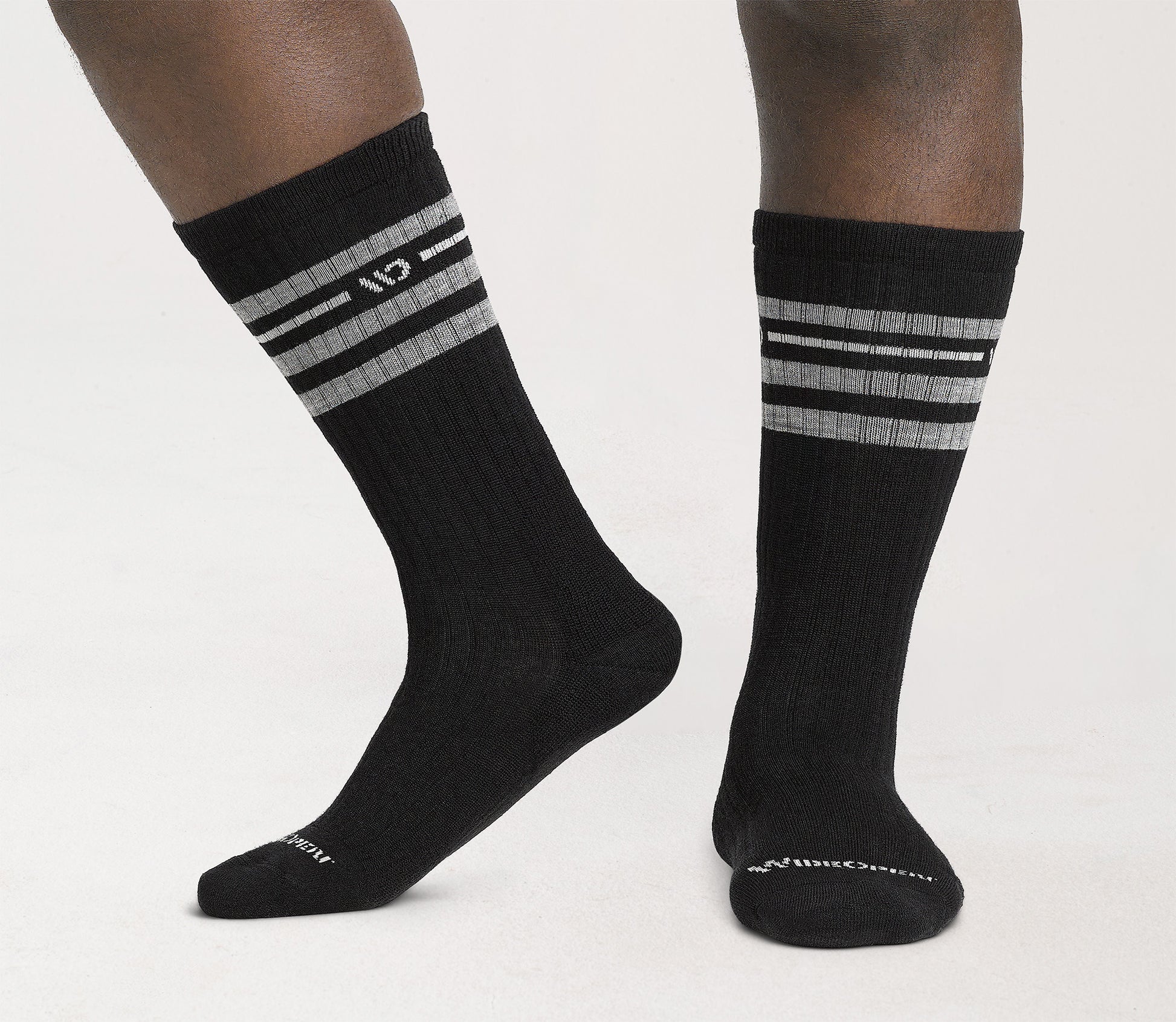 On model of the Black Crew with white logo, black body and gray stripes under cuff --Black