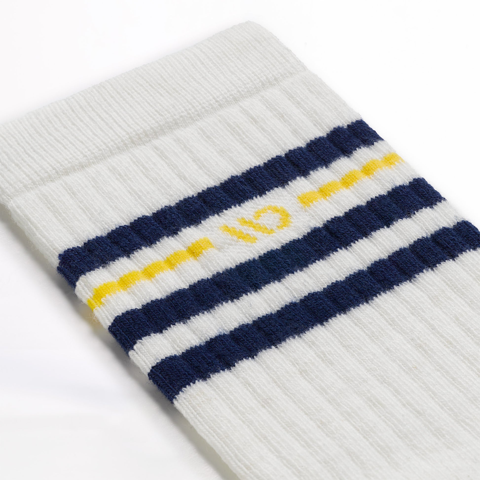 Detail image of the 9002 Vintage Crew sock in Ink white features include the yellow logo and blue stripes at the cuff