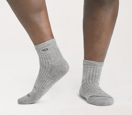 on model image of feet crossed wearing the 9004 solid Quarter sock in spruce