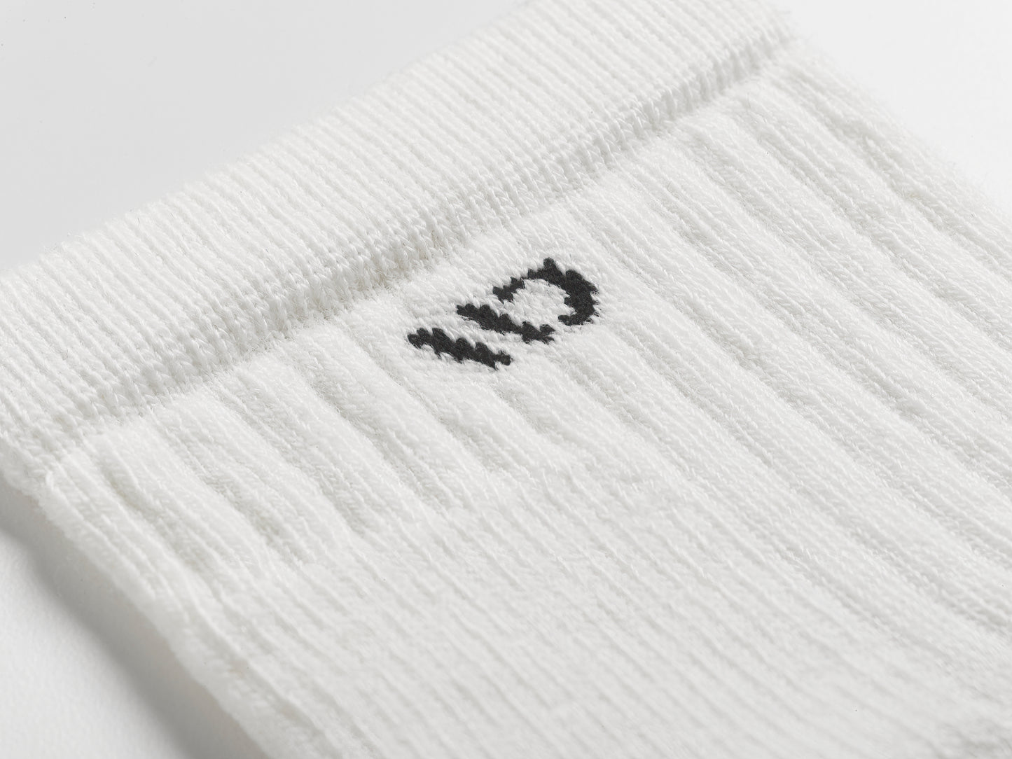 Close up detail shot of the 9004 in white with black logo