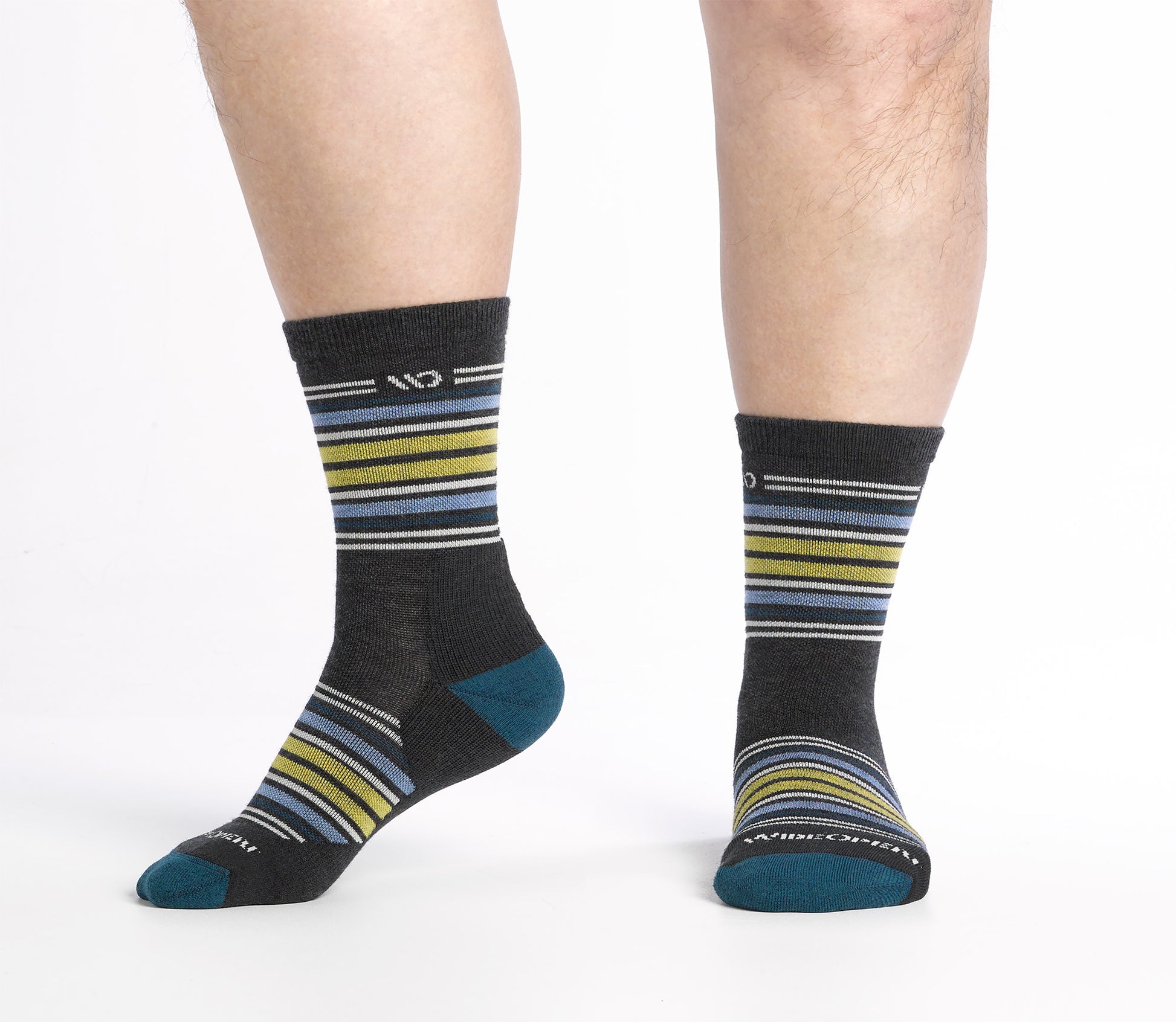 Side view on model shot of Micro Crew socks with teal heel/toe and Cream logo, Charcoal body and blue and yellow  stripes.