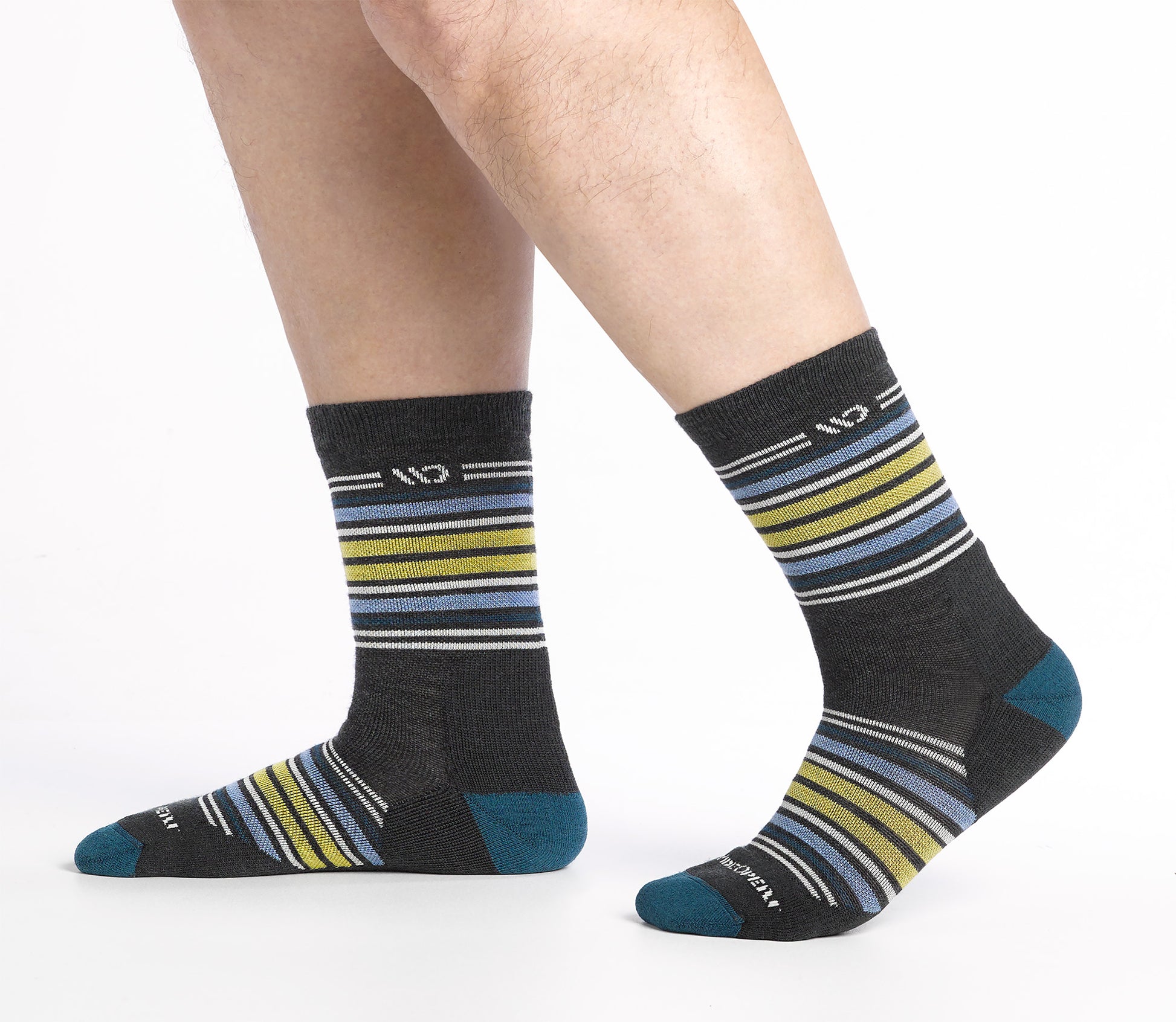 On model side shot of Micro Crew socks with teal heel/toe and Cream logo, Charcoal body and blue and yellow stripes.