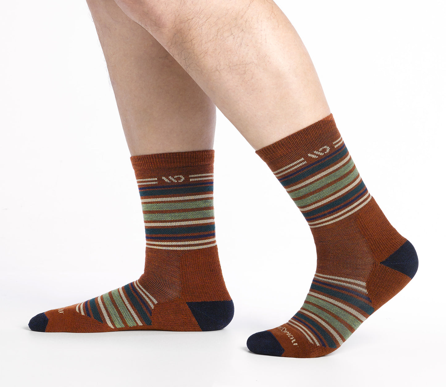 On model side shot of Micro Crew socks with dark heel/toe and Cream logo, Rust body and blue and green  stripes.