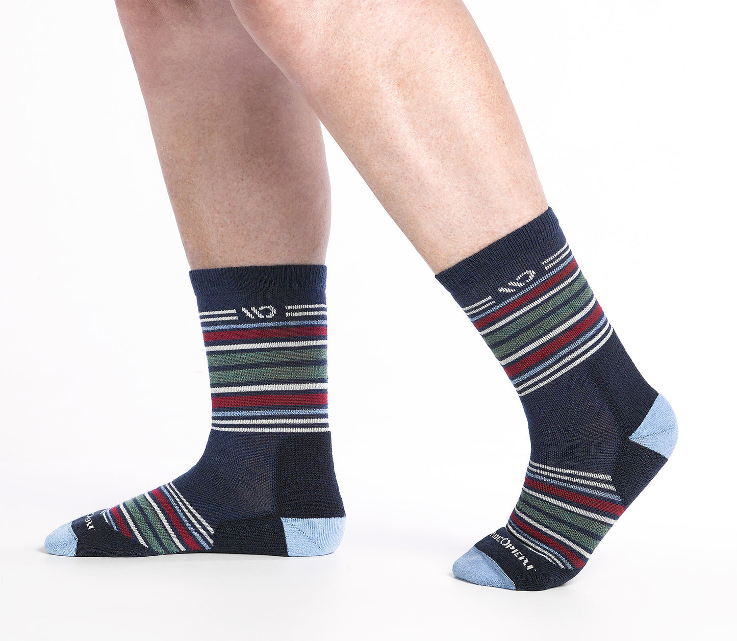 On model side shot of Micro Crew socks with blue heel/toe and Cream logo, Navy body and red and green  stripes.