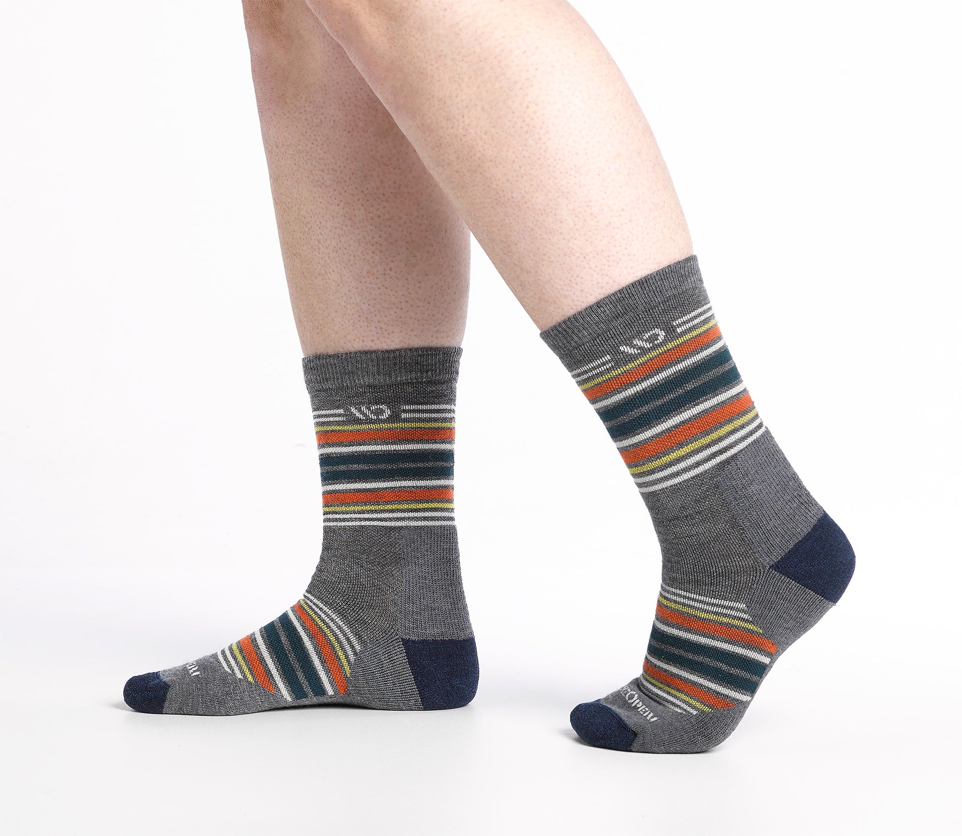 On model side shot of Micro Crew socks with Navy heel/toe and Cream logo, Gray body and blue and orange stripes.