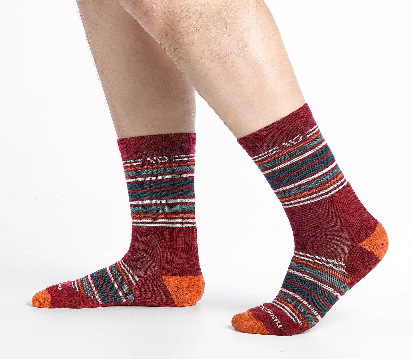 On model side shot of Micro Crew sock with orange heel/toe and Cream logo, red body and  green and orange  stripes.