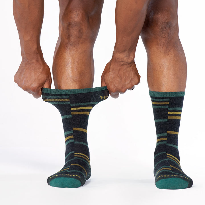 Model stretching the cuff of the 9010 crossroad cushioned crew in charcoal 