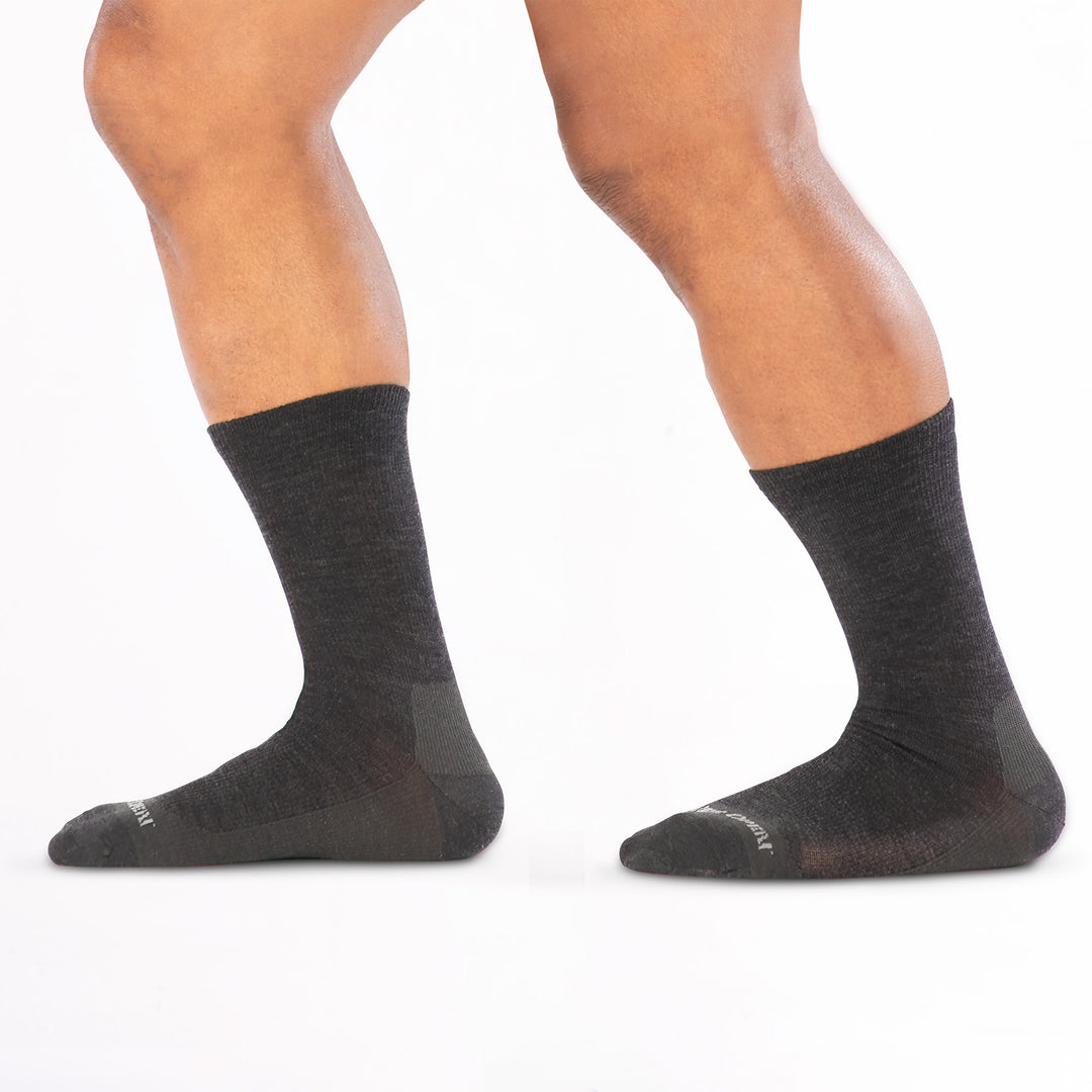 model walking to the left wearing the 9012 solid lightweight crew in charcoal