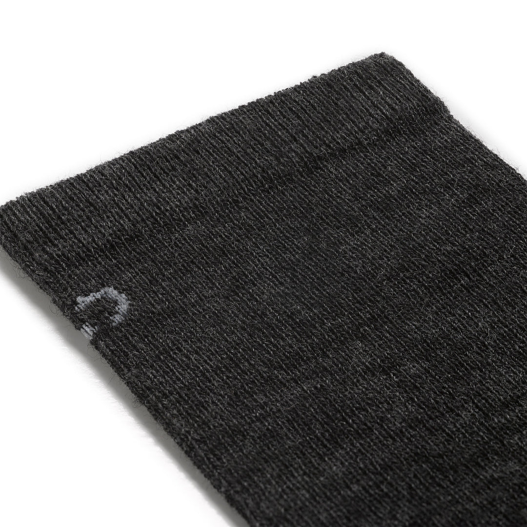 Detail image of mens solid lightweight crew 9012 in charcoal close up of cuff featuring light gray logo on charcoal body