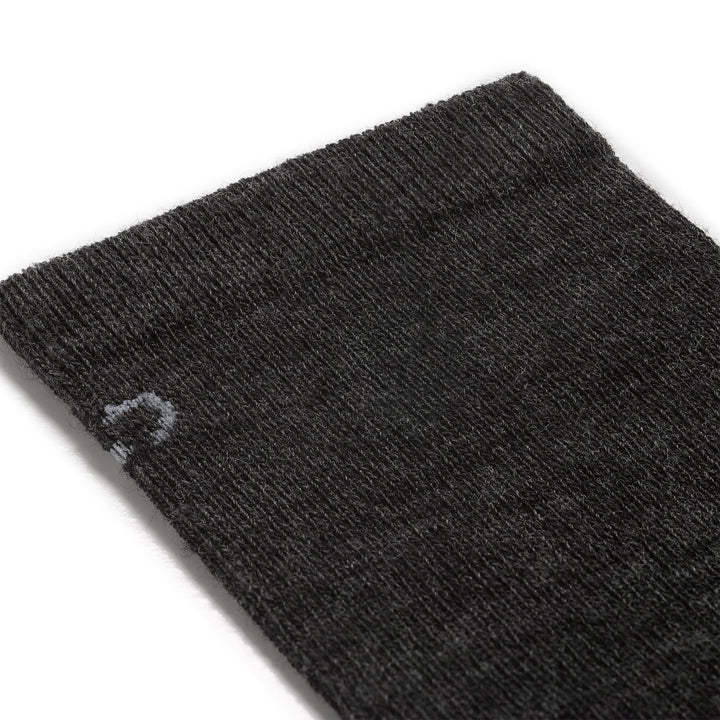 Detail image of mens solid lightweight crew 9012 in charcoal close up of cuff featuring light gray logo on charcoal body