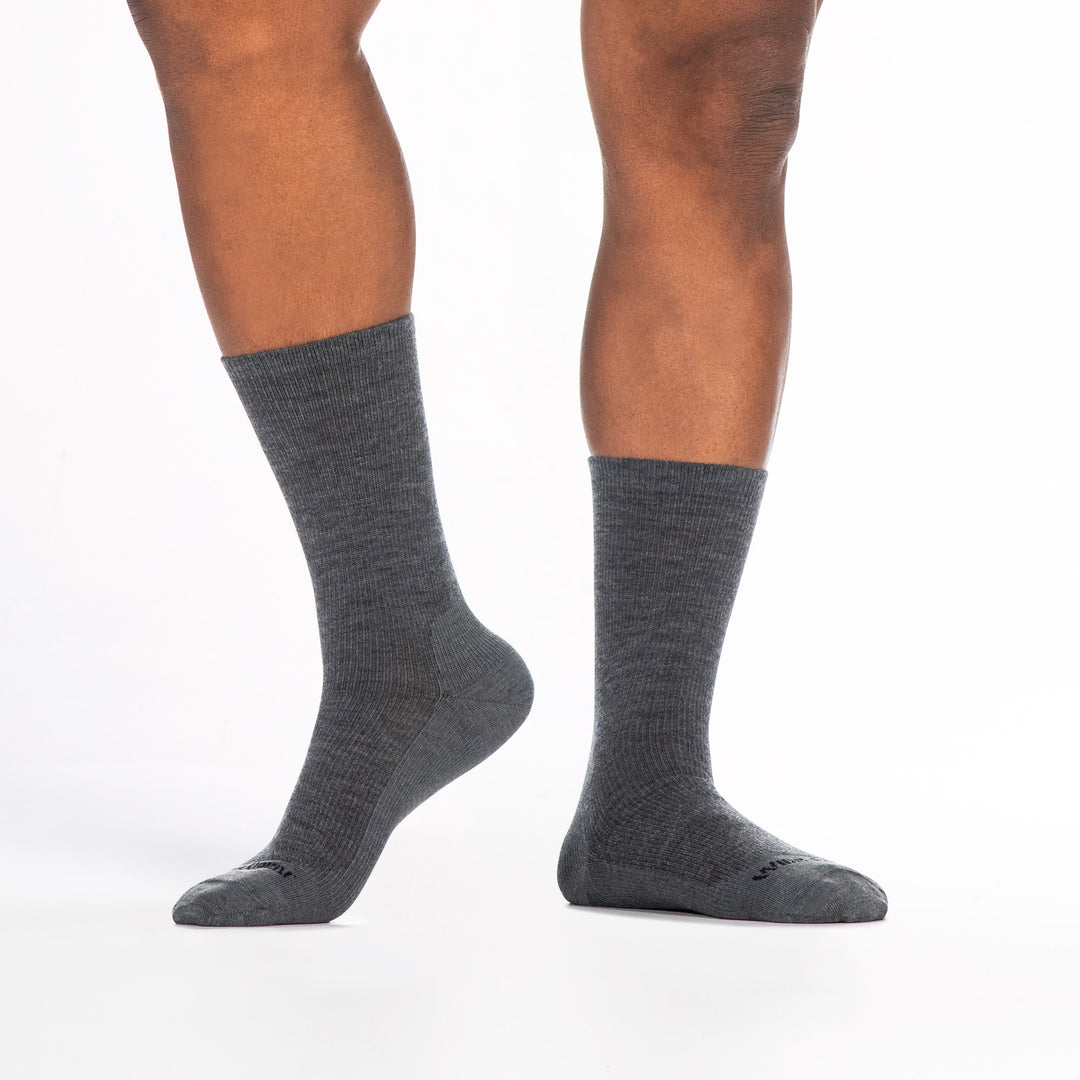 9012 gray crew sock with black logo shown from the front and side left foot to the side and heel raised