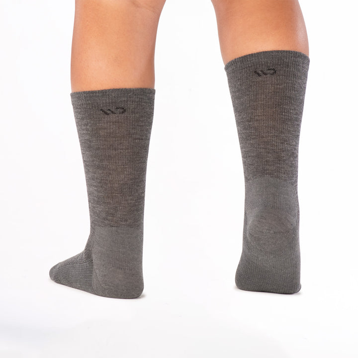 model image from behind with right foot raised wearing the 9012 solid lightweight crew in gray