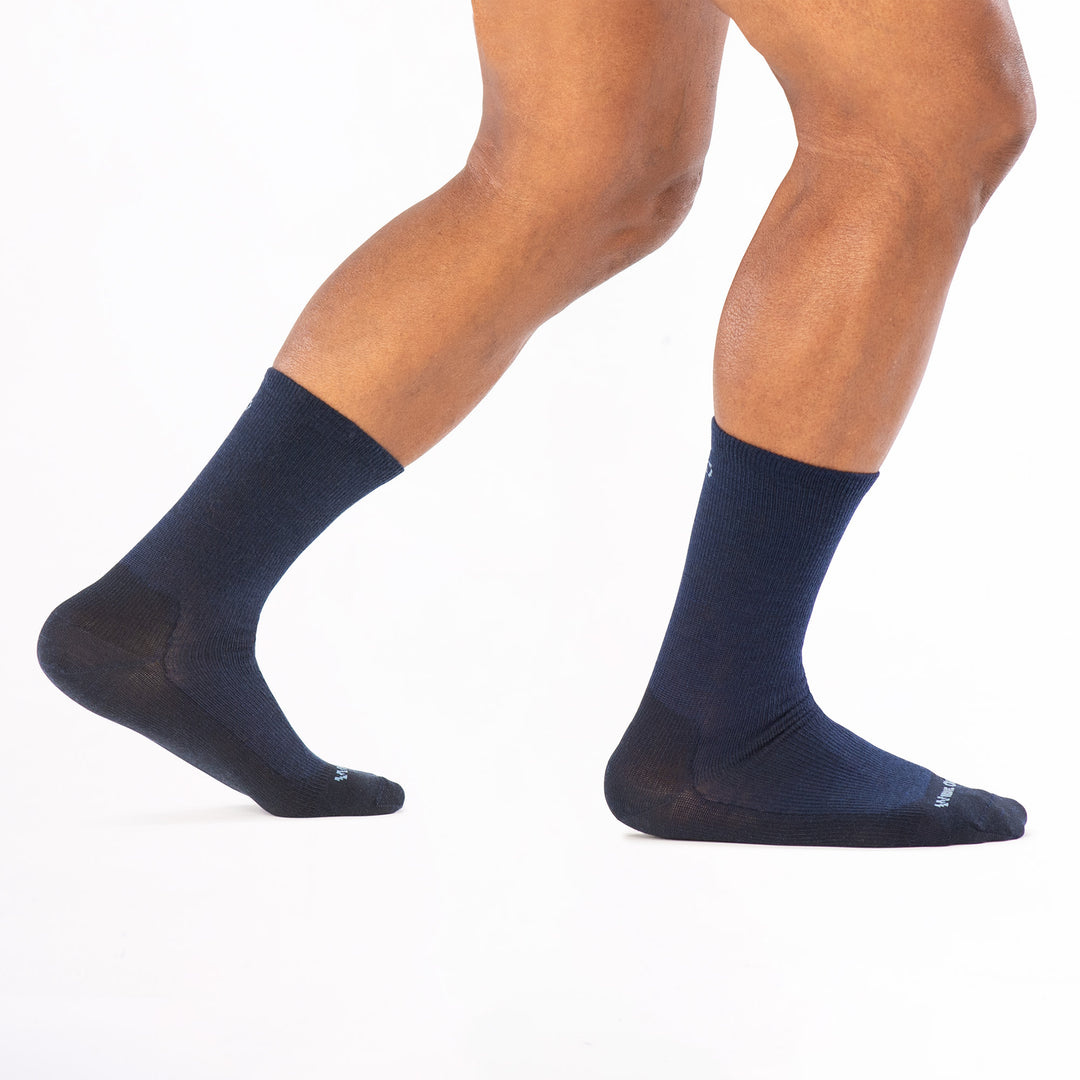 model walking to the right back foot raised wearing the 9012 solid lightweight crew in navy