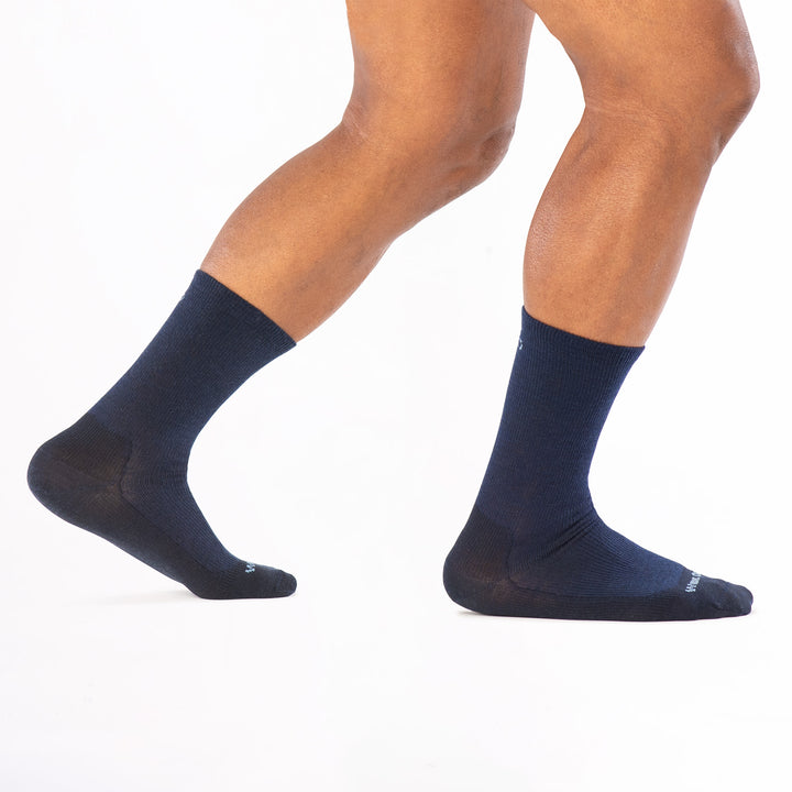 model walking to the right back foot raised wearing the 9012 solid lightweight crew in navy