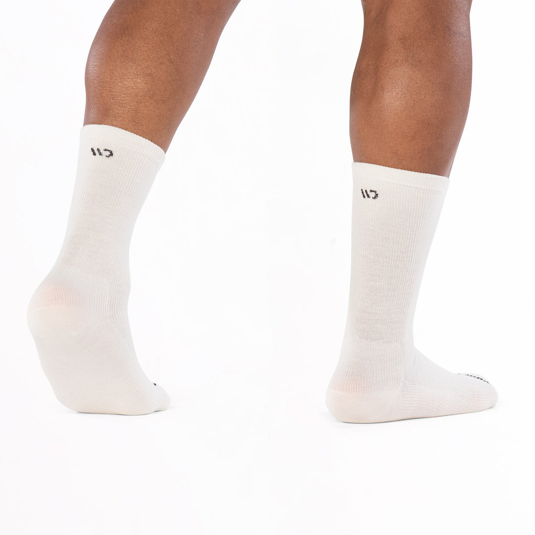 models feet facing away with left foot lifted in 9012 solid lightweight crew in white